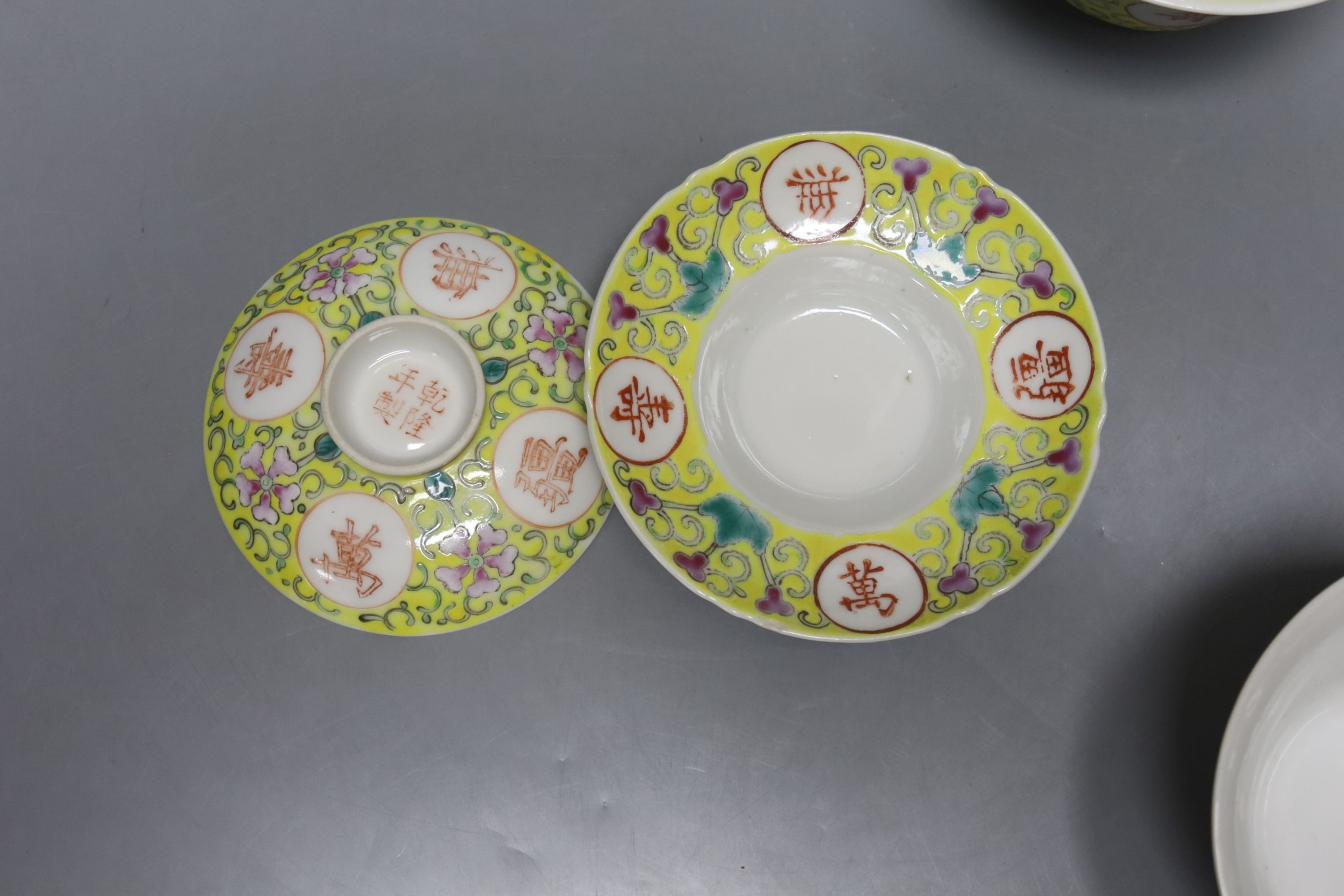 A pair of Chinese enamelled porcelain rice bowls, covers and stands and an odd bowl